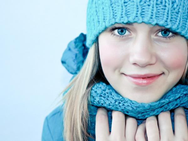 Beautiful girl in blue winter hat and scarf